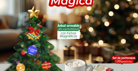 Set navideño de regalos corporativos con árbol armable de fichas magnéticas y portavasos personalizados sobre una mesa decorada, con fondo de árbol de Navidad iluminado.